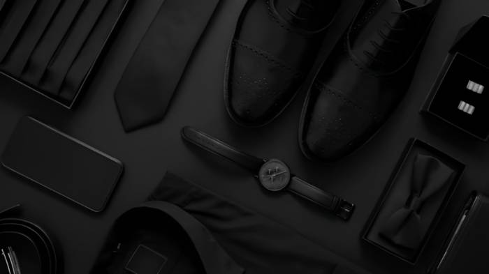 An image of a collection of timeless accessories, such as a leather watch, silk scarf, and classic leather briefcase. These accessories are essential for achieving the sophisticated and classic Old Money Style for men.